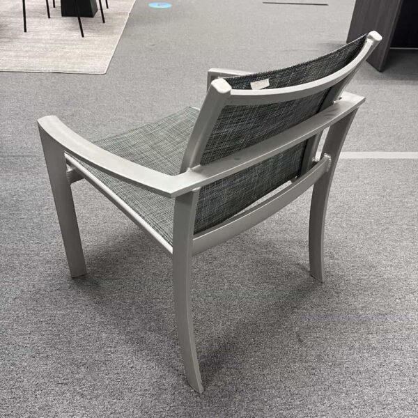 tropitone silver and grey chair with woven seat, angled back and up arms, stacking, back view