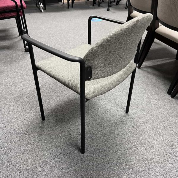 kimball green upholstered stacking chair with black base and arms