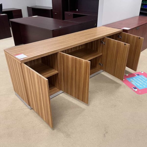 striped laminate walnut maple credenza cabinet with silver band around the base, open doors