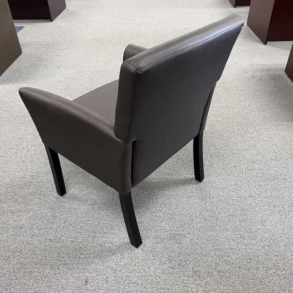 brown vinyl patron chair with black wood legs