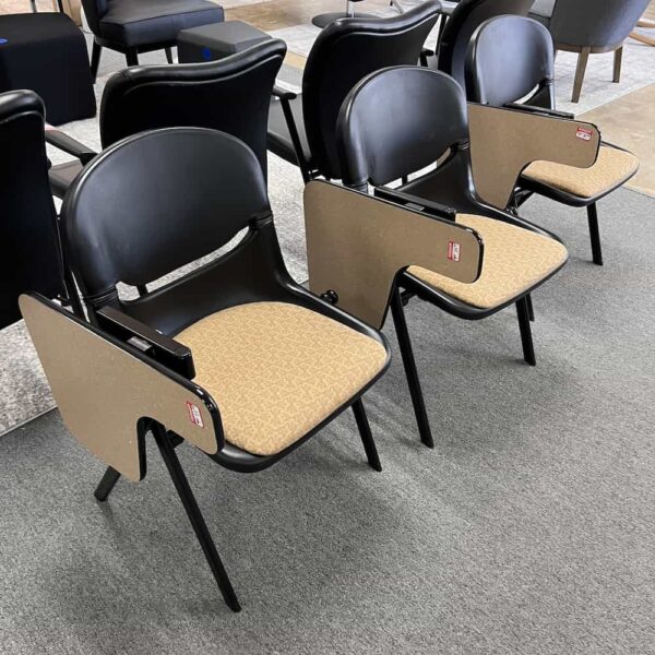 tan laminate table with black plastic seat with tan upholstered seat. School chair with retracting table