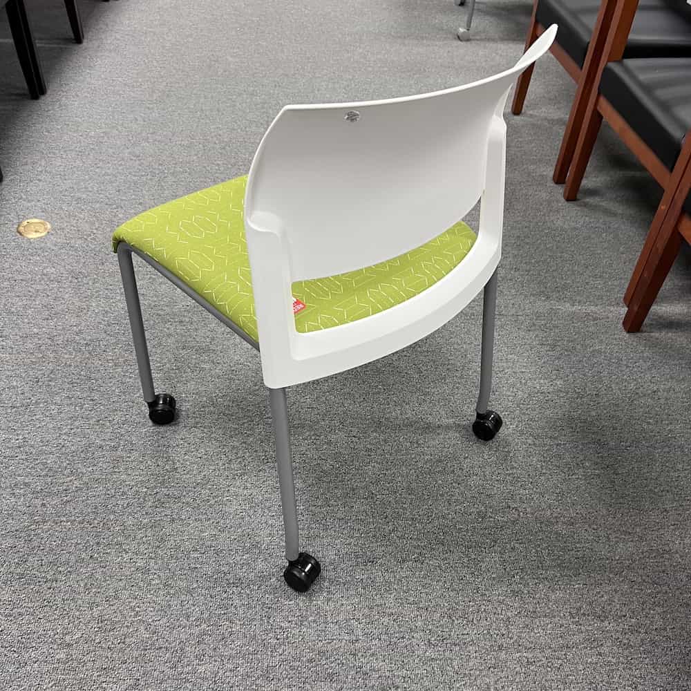 white black plastic back with green upholstery seat, silver legs and rolling wheels, stacking steelcase move chair used