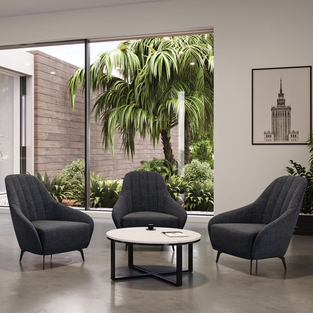 round modern coffee table with laminate top and black legs with three lounge arm chairs surrounding