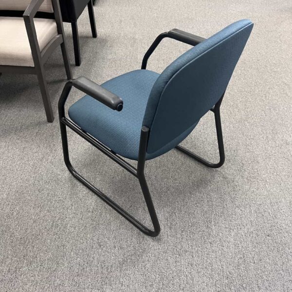 teal upholstery guest chair with black legs enwork seating