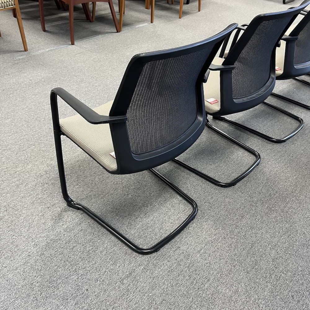 tan upholstered with black mesh back guest chair teknion projek