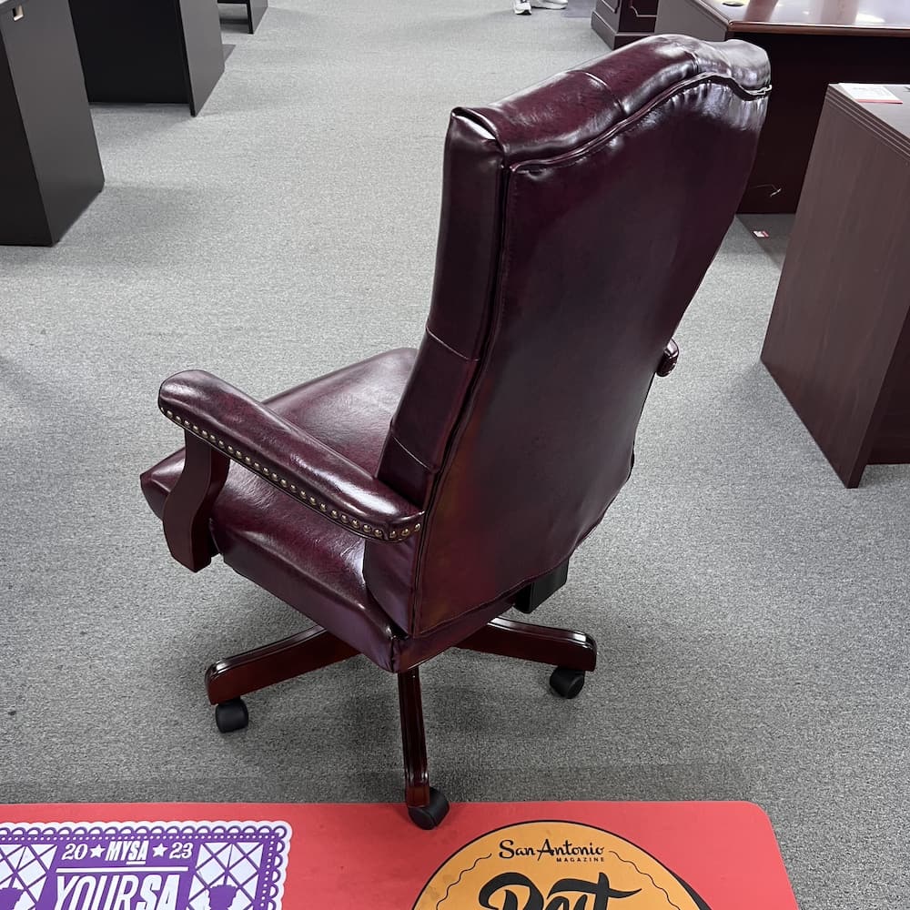 burgundy vinyl executive chair with high back and cherry 5 star base and arms details